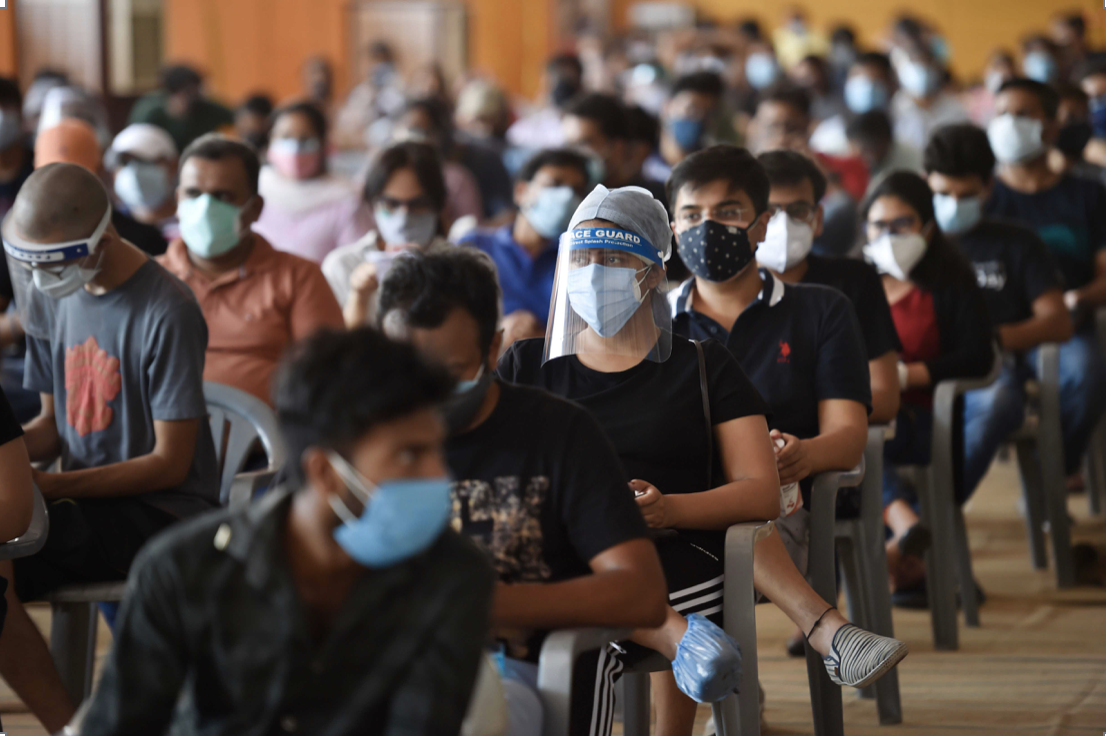 Masked Group waiting to get COVID vaccine
