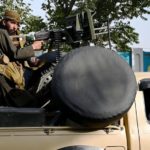 Taliban with sub-machine gun mounted in pick-up