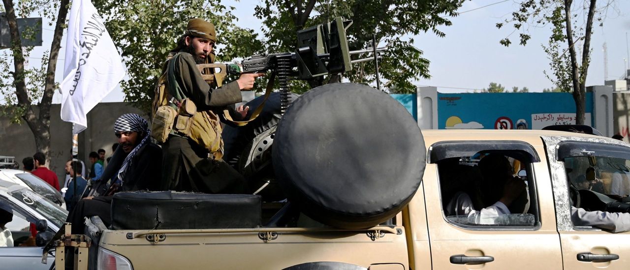 Taliban with sub-machine gun mounted in pick-up