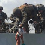 soldiers save a baby over concertina wire