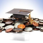 mortarboard on pile of coins