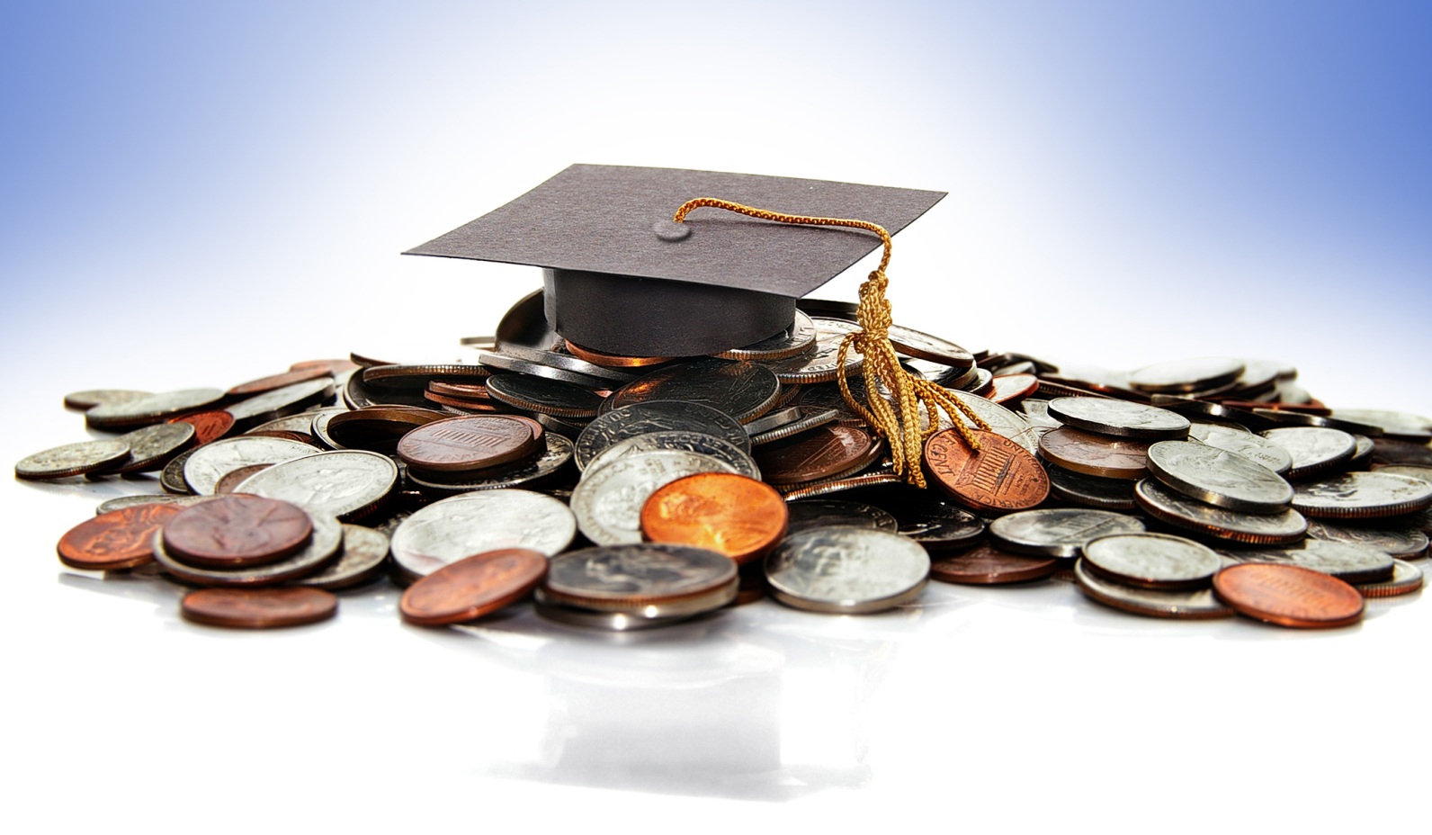 mortarboard on pile of coins