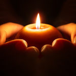 prayer candle cupped-hands