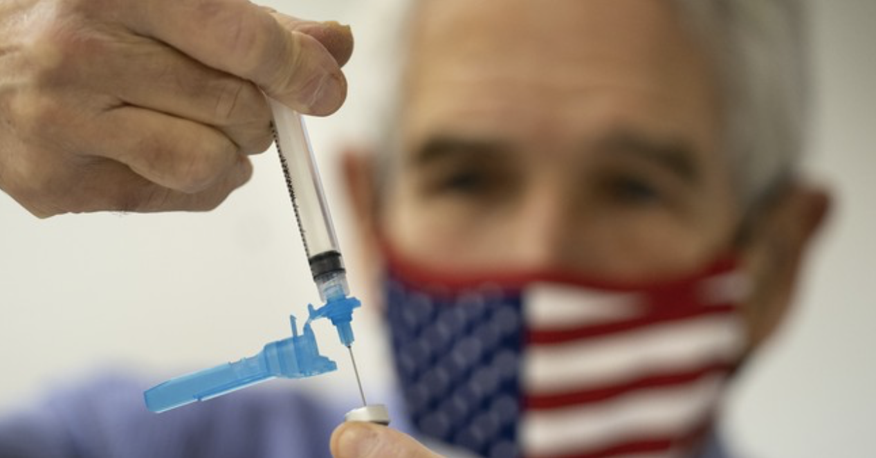 Vaccine syringe US flag masked person