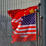 Chinese flag above USA American Flag