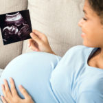 Pregnant-black woman-holding-ultrasound