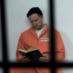 Inmate reading Bible