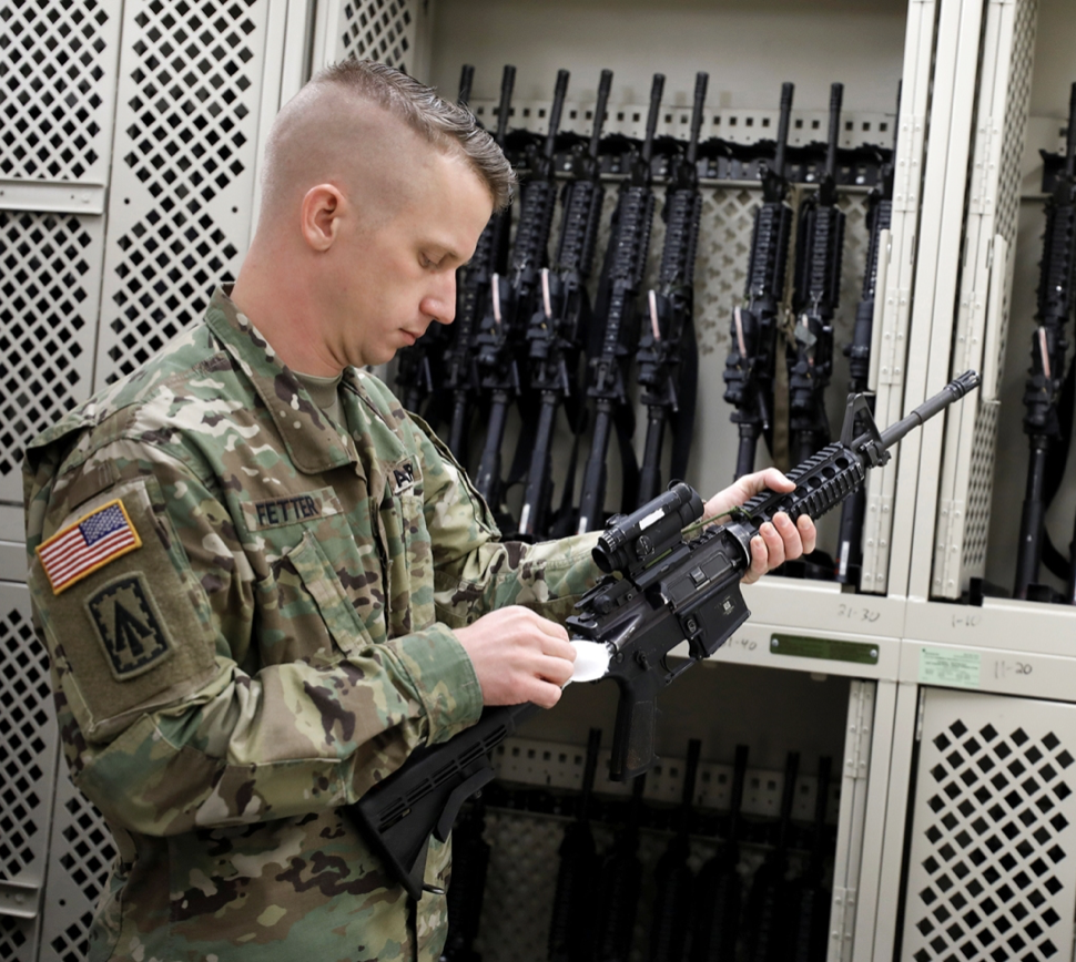 Army Paratrooper readies weapons
