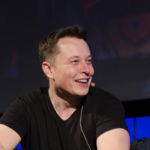 Elon Musk speaks wearing headset