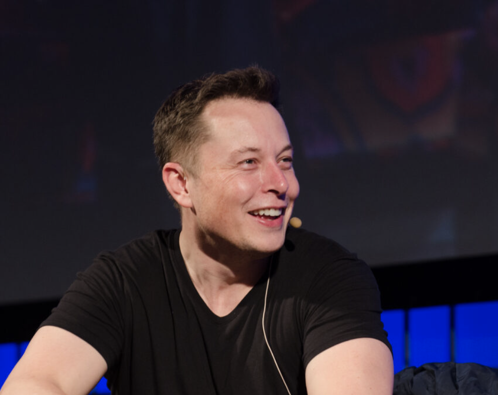 Elon Musk speaks wearing headset