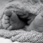 baby feet in knitted blanket - B&W