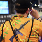 Man in flowered shirt with ak-47 print