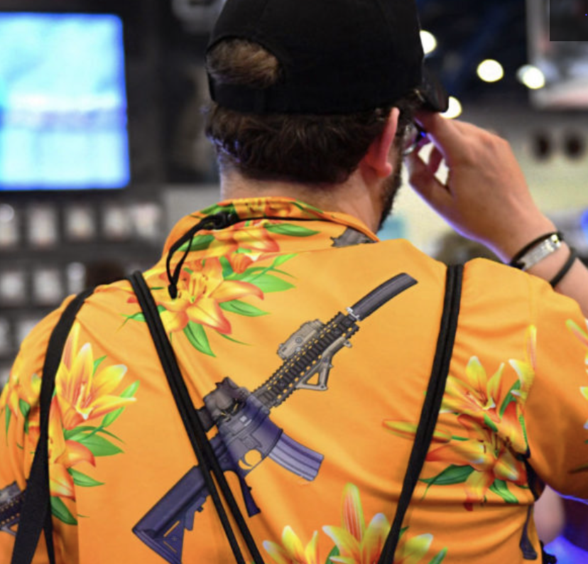 Man in flowered shirt with ak-47 print