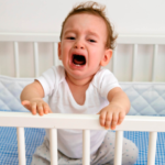 baby crying standing in crib