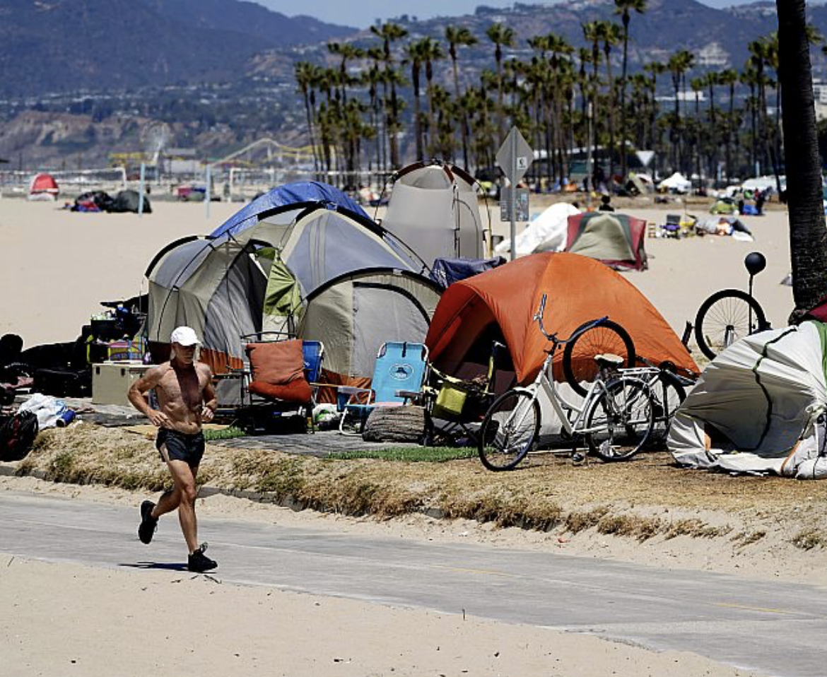 Jogger runs past homeless tents