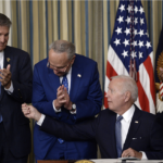 dems clap as Biden signs Inflation Reduction Act