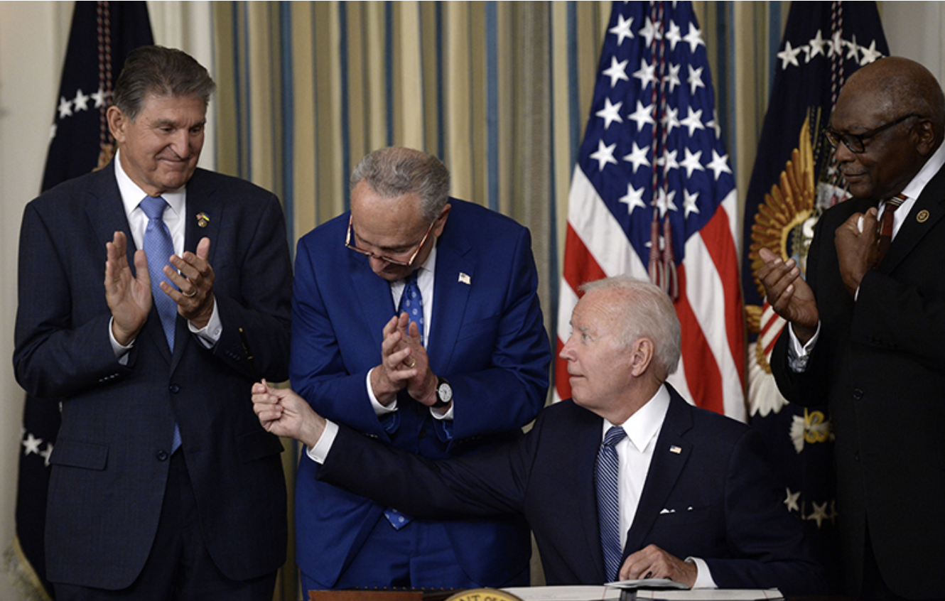 dems clap as Biden signs Inflation Reduction Act