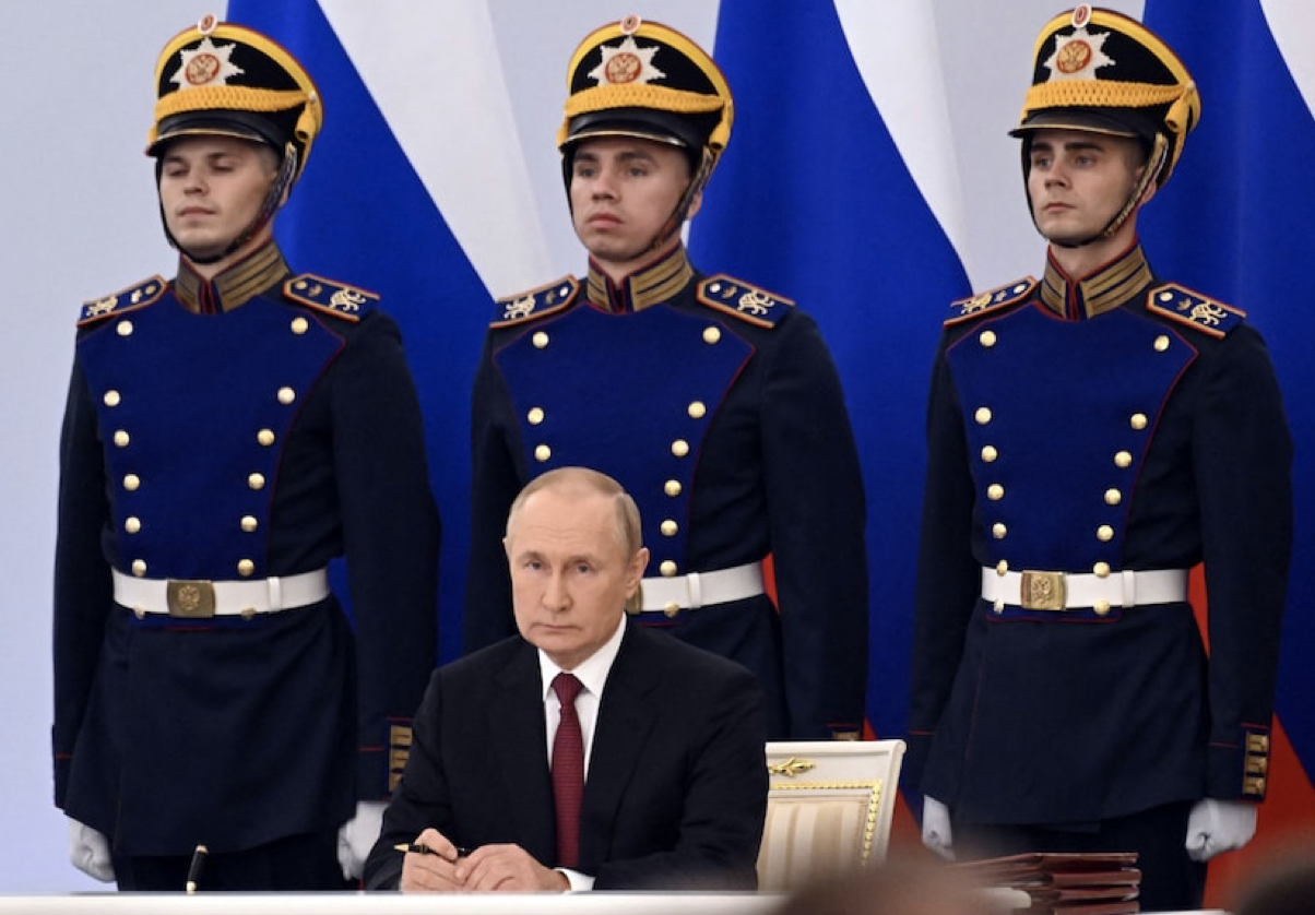 Putin flanked by guards signs annexations