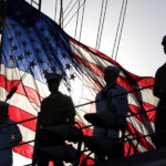 us flag on deck with crew