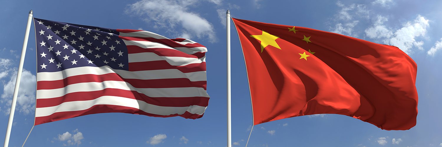 American-Chinese windy day flags fly on flagpoles