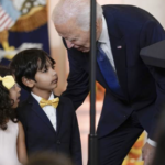 Biden bends over to talk to small boy & girl