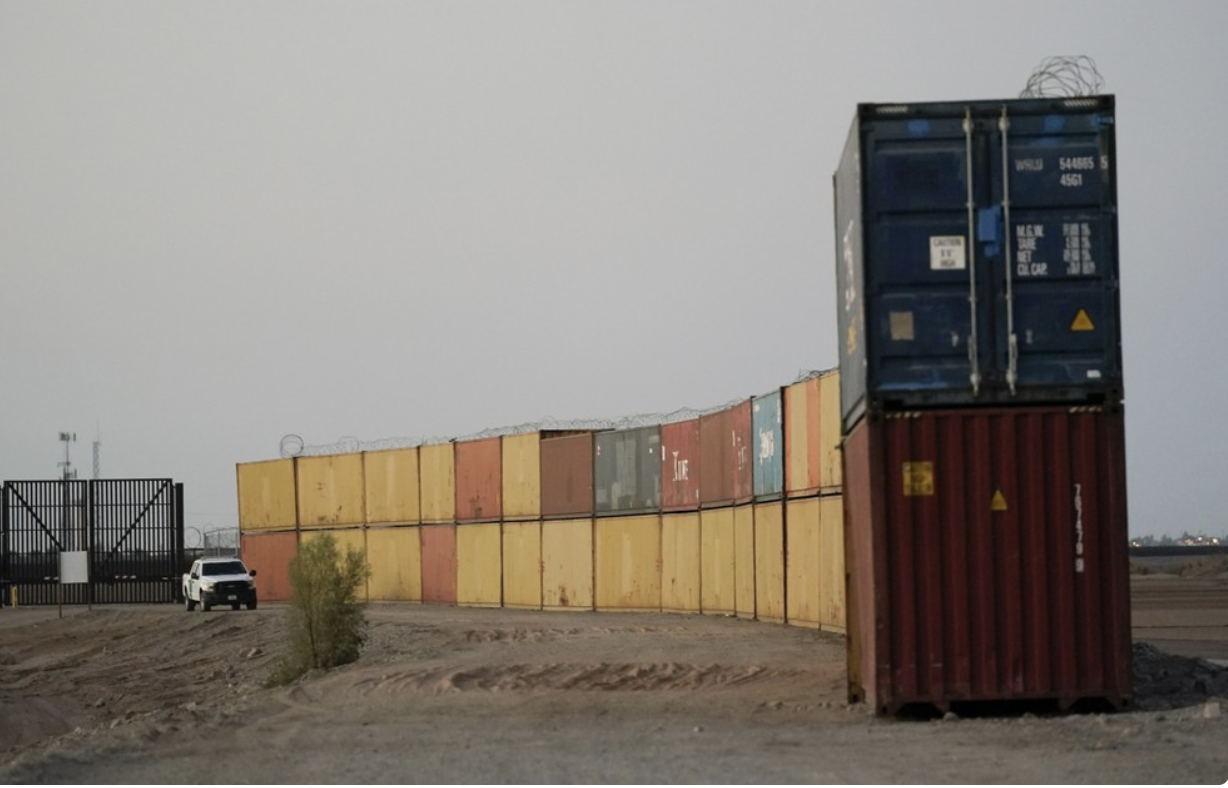 Row of double-stacked shipping containers = border wall