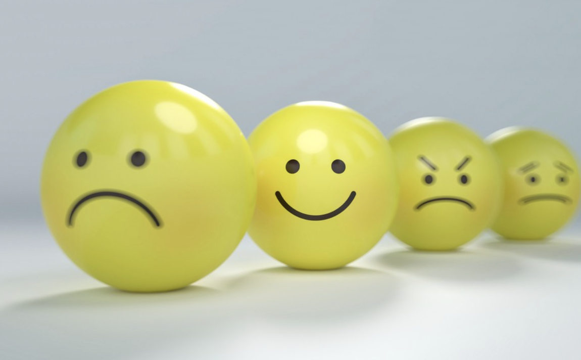 row of emoticons w happy sad & meh faces