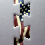 Gray Puzzle pieces separated with US Flag behind them