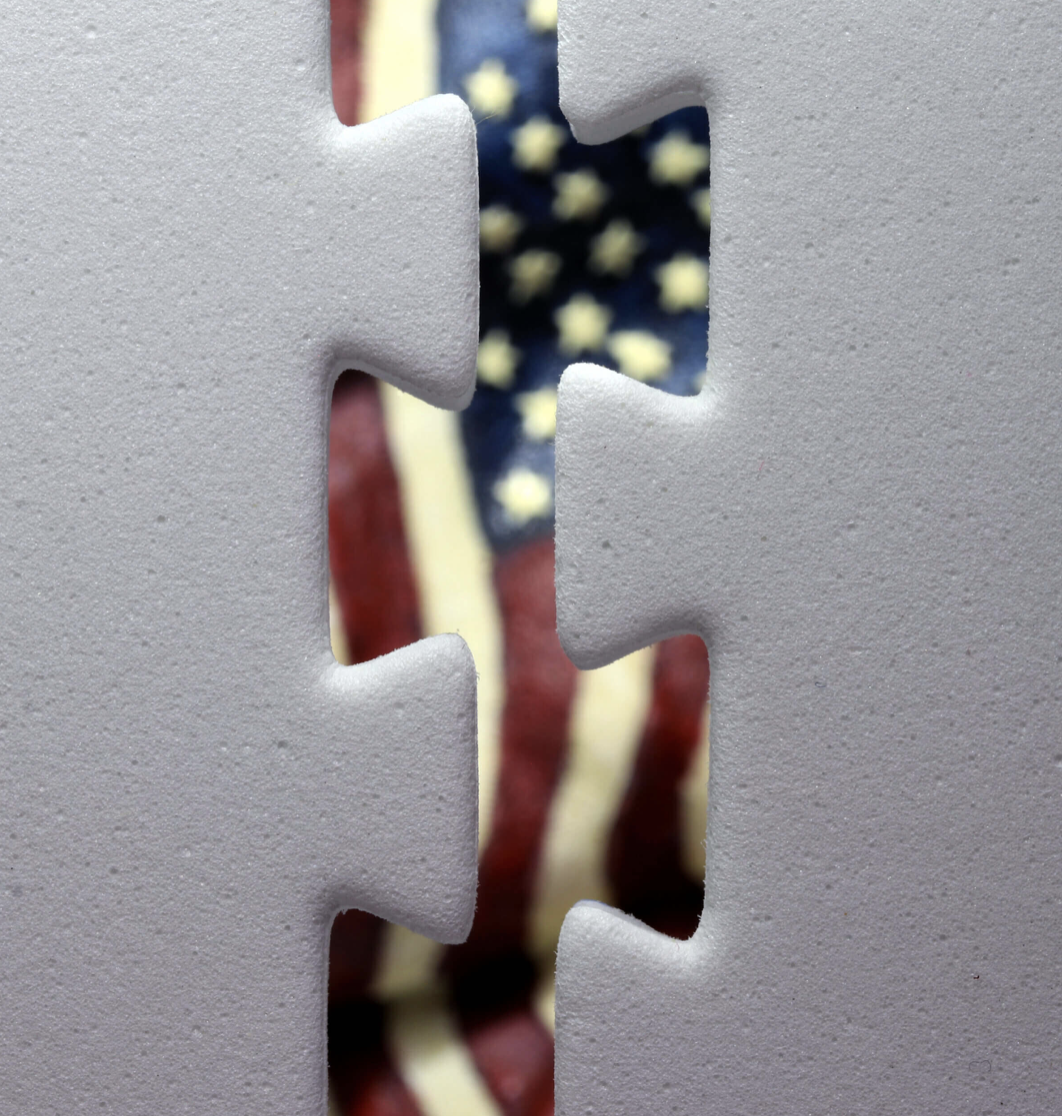 Gray Puzzle pieces separated with US Flag behind them