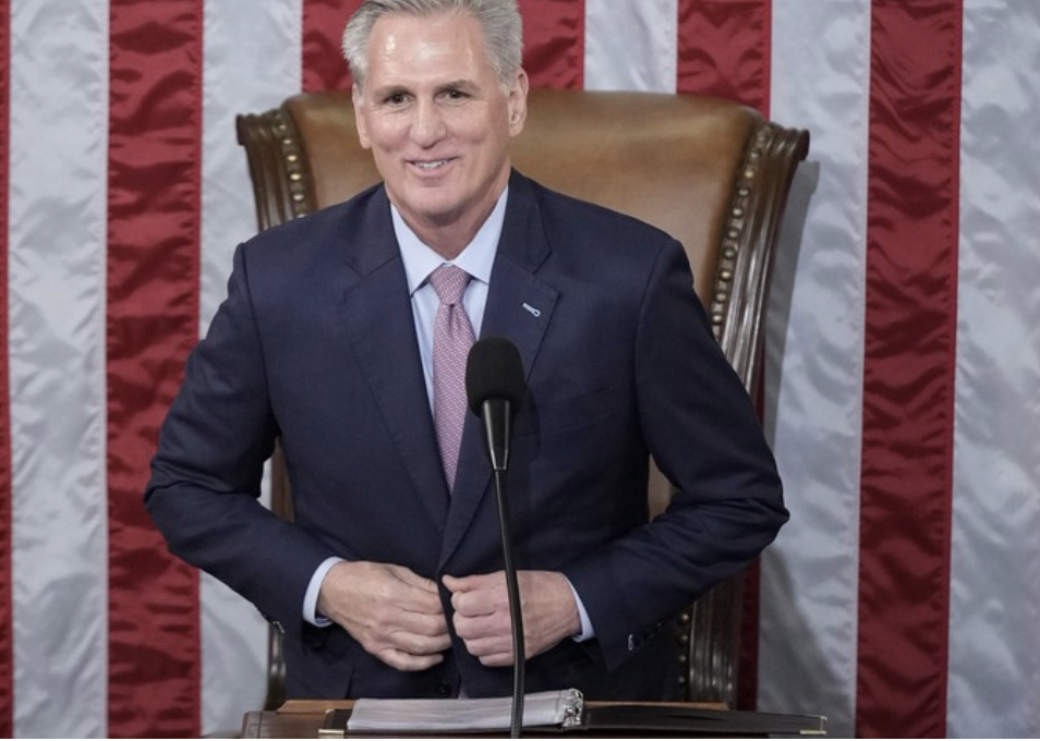 Kevin McCarthy standing at Speakers's desk - buttoning suit