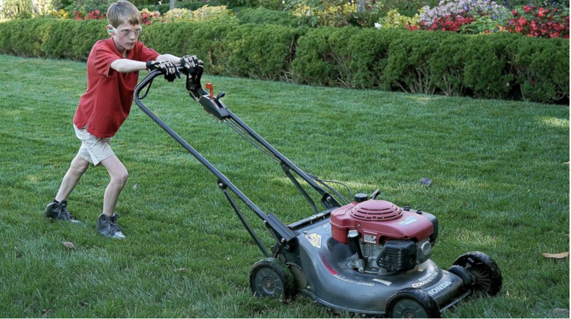 boy mowing the lawn