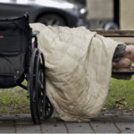 Homeless amputee sleeps on a park bench