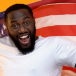 Smiling Afro-American man with USA flag celebrating