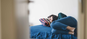 depressed white woman on a bed