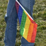 Person holding rainbow flag