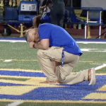 Coach Kennedy kneels after foodball game