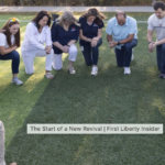 circle group kneels in prayer