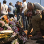 Friends and relatives of Ilai Bar Sade mourn next to his grave