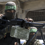 Hamas soldier holding automatic mounted gun