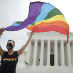 Joseph Fons waves Pride flag on Supreme Court steps