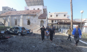 Palestinians carry injured person twoard Al-Ahli