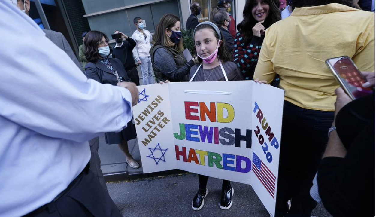 girl holding tri-fold poster Jewish & Trump supporter
