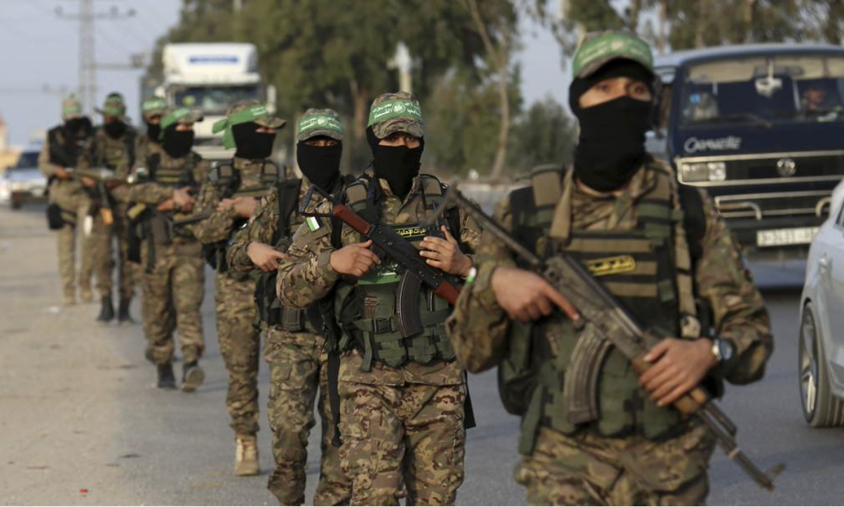 line of masked Hamas soldiers walking