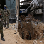 Israeli soldier stands near tunnel opening under Al-Shifa Hospital