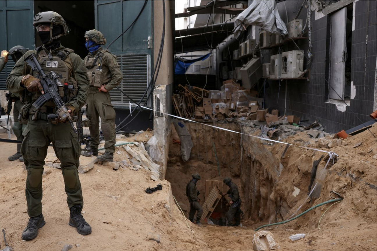 Israeli soldier stands near tunnel opening under Al-Shifa Hospital