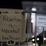 Paper handwritten sign - Abortion is essential healthcare