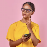 girl with smartphone in pink studio