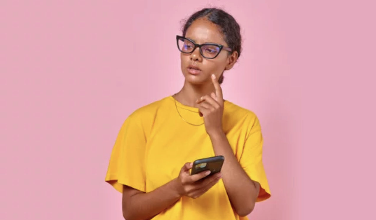 girl with smartphone in pink studio