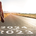 woman runner at start-line leaving 2023 for 2024 - stretching
