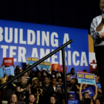 Biden on campaign stage build back better banner